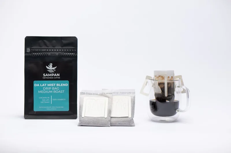 Sampan drip-bag format overview: a coffee bag, individual sachets, and a freshly brewed cup